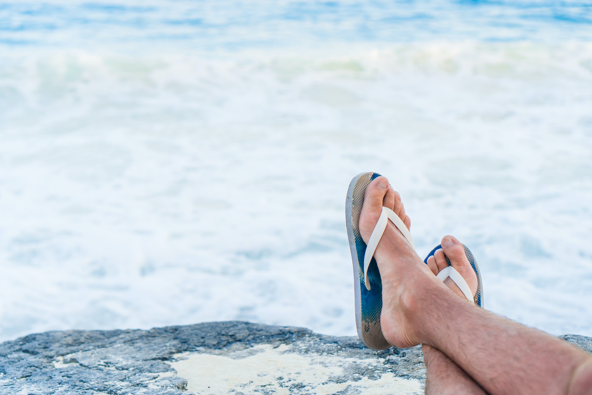 Close up of male legs background the sea