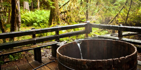 "Estacada, Oregon, USA - October 4, 2011: Located in the Mt. Hood National Forest, the Bagby natural hot springs are fed by three major springs with an average temperature of 131 degrees F.  This is one of the several public bathing tubs that are available 24 hours to visitors who come to the site."