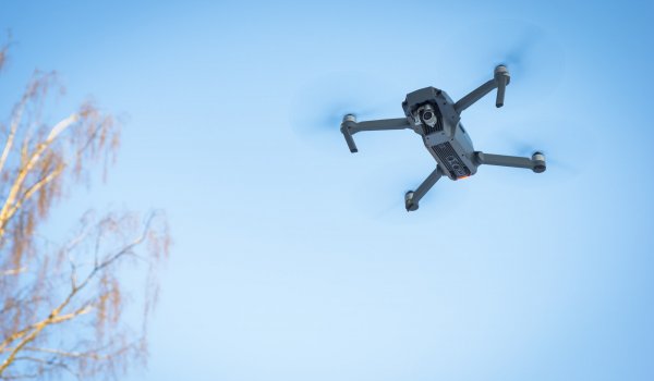 Drone flying in the blue sky, unmanned copter flight Drone flying in the blue sky, unmanned copter flight