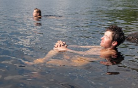 Loving couple in the summer water lake