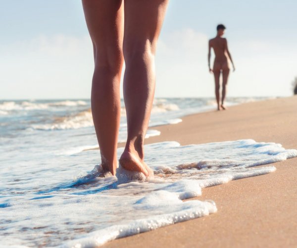 nude young girls walk on the beach in the waves of the surf on a summer day nude young girls walk on the beach in the waves of the surf on a summer day