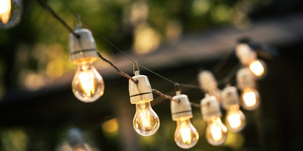 outdoor string lights hanging on a line in backyard