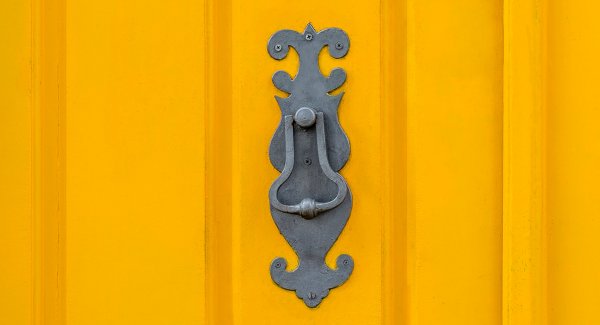 Old knockers on colored doors