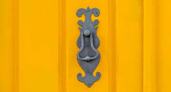 Old knockers on colored doors